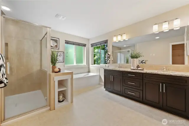 En suite Tiled shower, bathtub and dual vanity.