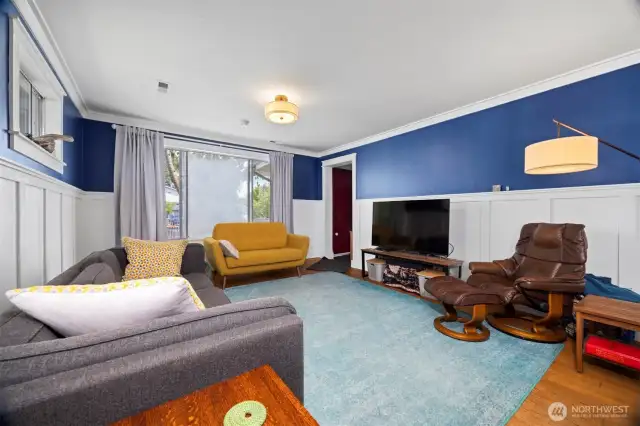As you enter, you will notice the beautiful fir floors and the wainscoting in the generously sized living room.