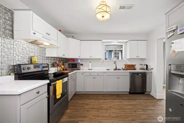 The kitchen has been nicely updated and has LVT flooring and lovely shaker style cabinets. There are newer stainless steel appliances, too.