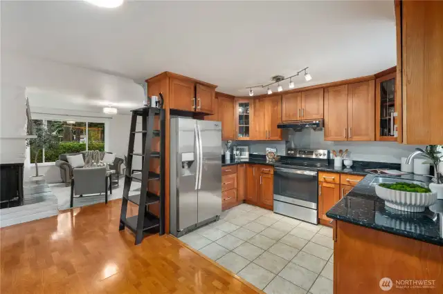 The kitchen boasts ample cabinet space, stainless steel appliances and granite countertops