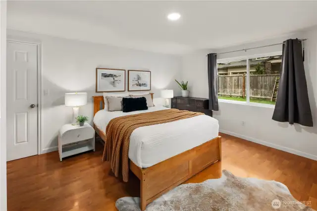 The spacious primary bedroom lets in plenty of natural light, making it a relaxing retreat