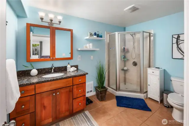There is a three quarter ensuite bath off of the primary bedroom which includes an enclosed stand-up shower