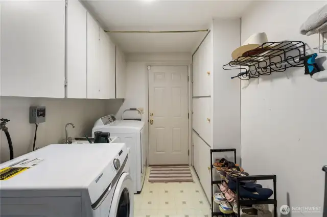 A separate utility & mud room hosts the washer, dryer, and cabinets for extra storage