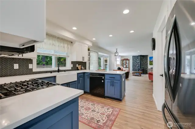 Remodeled tuxedo style kitchen with blue lower cabinets and white uppers