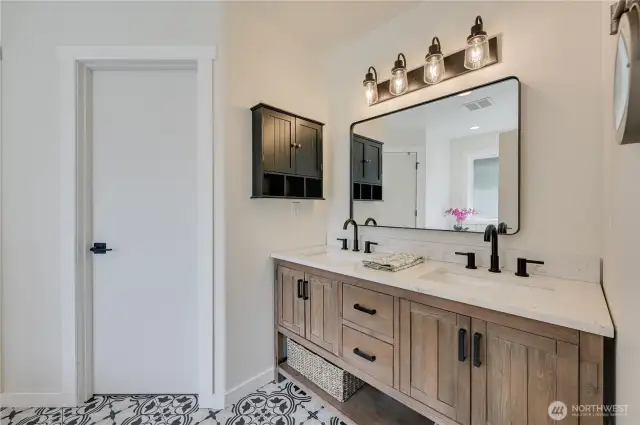 Remodeled 5 piece bath in primary suite.  Look at those gorgeous floors!  Door seen here leads to spacious walk in closet