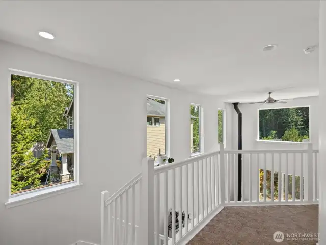 Loft area open to the main floor with lots of windows for natural light even on cloudy days