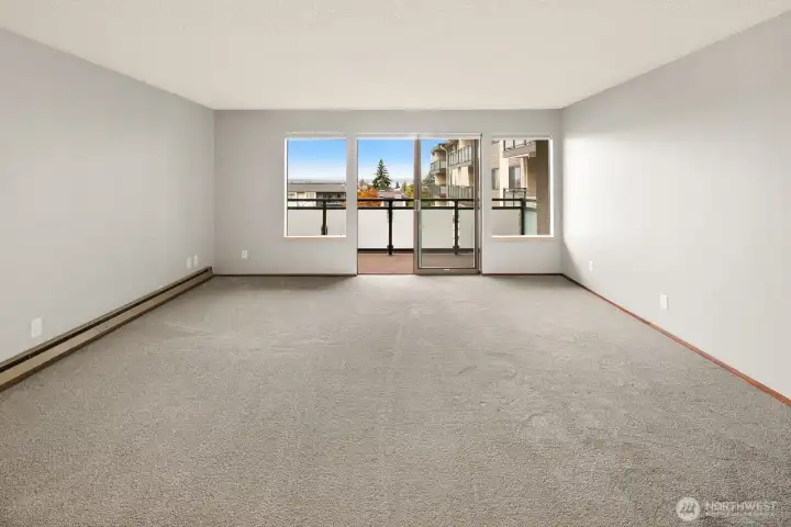 Open view of the living room out to the balcony with views of Puget Sound & Whidbey Island.