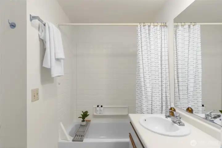 Full bathroom features a built-in closet with ample storage.