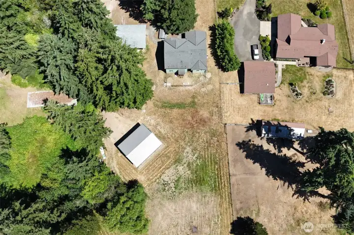 Aerial view of cleared portion of the backyard, which is only a small portion of the entire property.  Endless possibilities!  Massive garden?  Horses?  Chickens?  Goats?  All of the above???  Start your very own homestead or farm here!