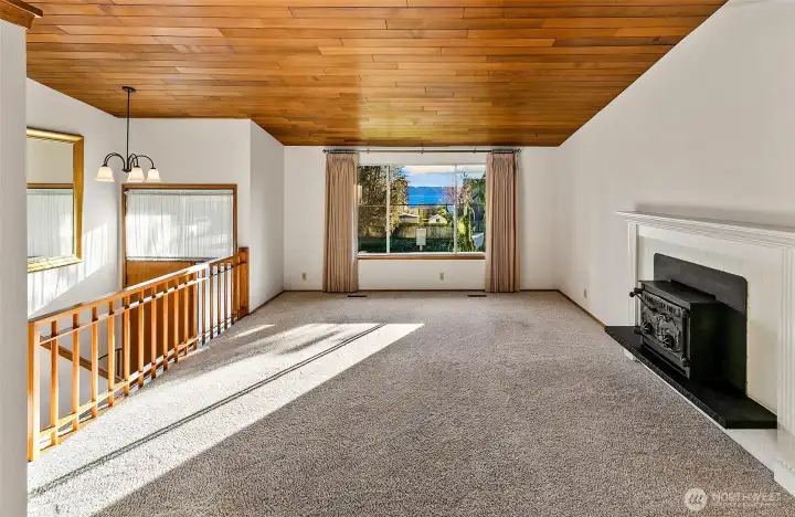 Main level, upstairs offers a peak-a-boo view to Puget Sound in the living room.