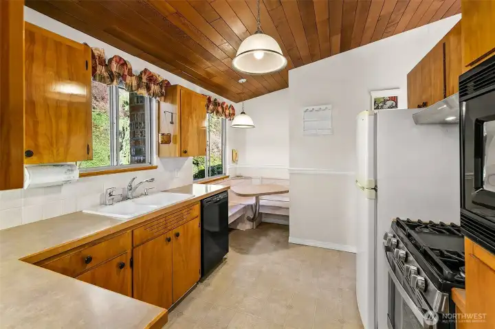 Kitchen offers a fun corner nook with built-in table for the family