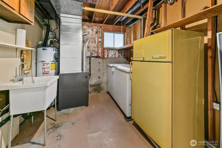 Laundry room on the lower level with wash sink and plenty of storage