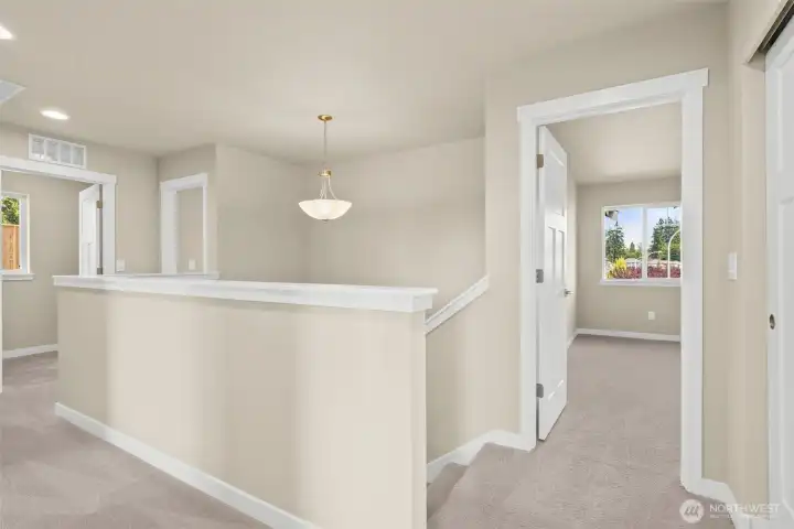 Landing area on second level that connects to the upper-level private rooms and laundry.