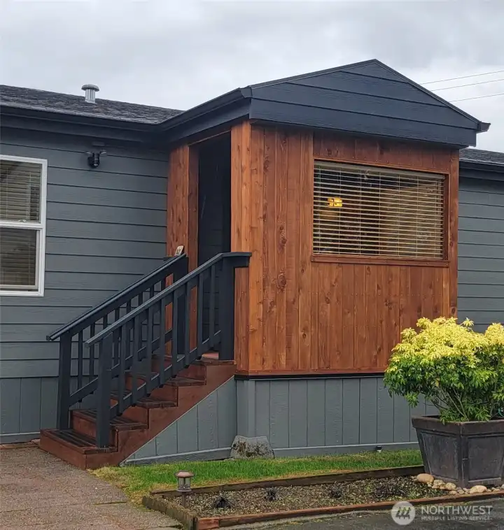 The enclosed entry porch offers a nice respite on stormy days.