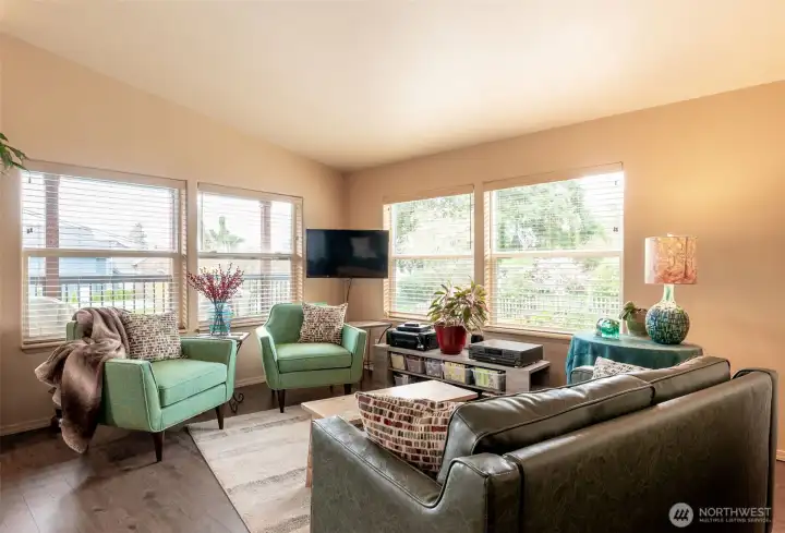The bright vaulted living room offers light, comfort and lovely views.