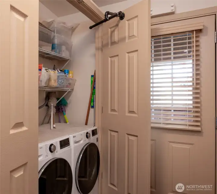 The washer and dryer hide behind paneled doors.