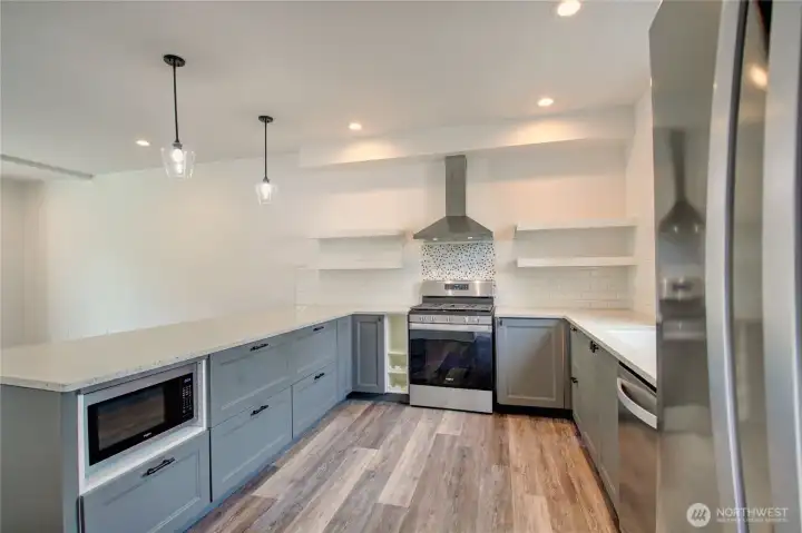 Stunning modern kitchen with quartz countertops, built-in microwave and beautiful cabinetry