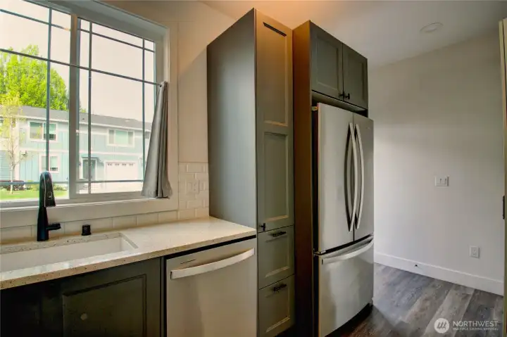 Stainless appliances, quartz countertops, and beautiful backsplash