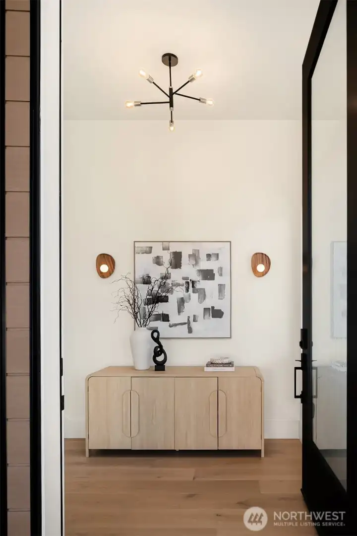 A dramatic 10-foot entry door welcomes you into the home, setting the stage for grand, yet warm, modern living.