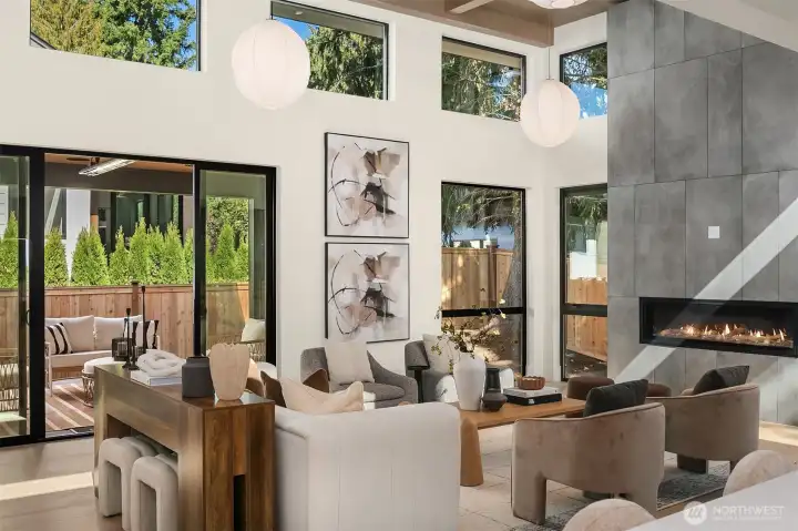 Expansive windows frame lush views, filling the space with natural light.