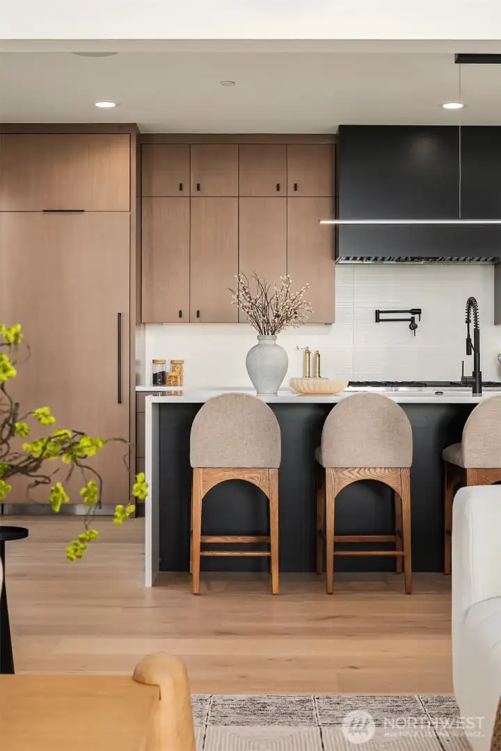 Full suite of professional Thermador appliances, 72" paneled refrigeration, dedicated pot filler, and walk-in pantry with room for a second refrigerator.