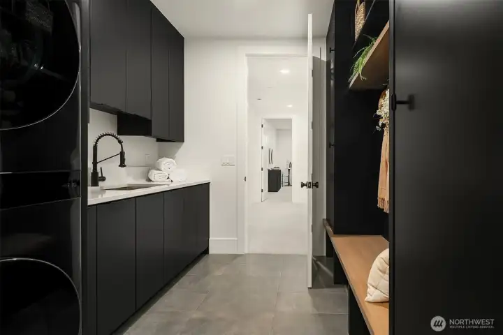 Direct access to mudroom with built-in benches and storage, keeping life organized and clutter-free.