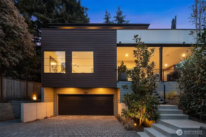 Professionally landscaped with mature plantings and custom outdoor lighting throughout.