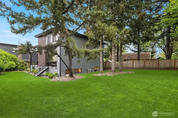 The expansive yard is fully level and completely fenced for privacy and pet safety.