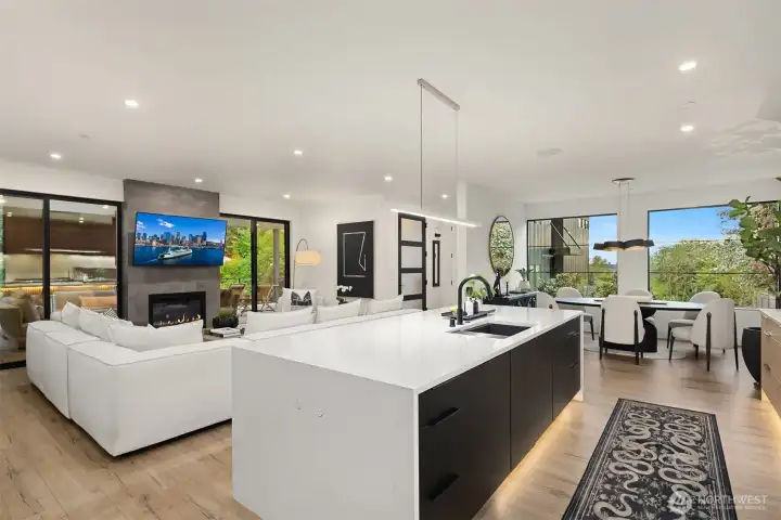 The beautiful dual gas fireplace is flanked by sliding doors leading to the covered outdoor living room.