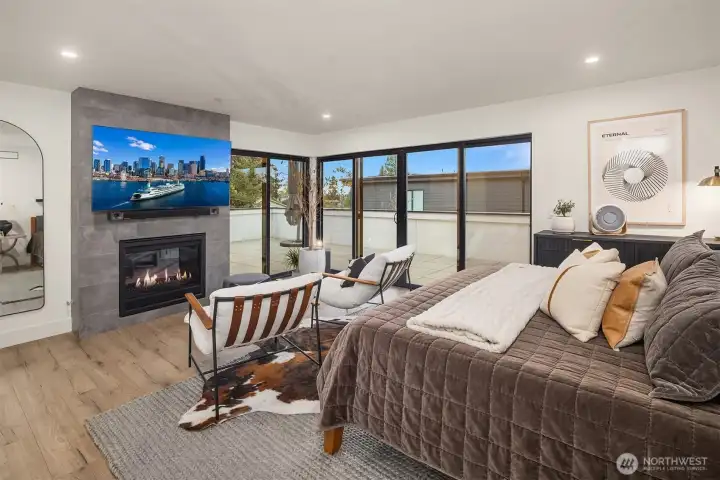 The sumptuous Primary suite, with dual gas fireplace and completely surrounded by large tile outdoor living space and Western sky views.