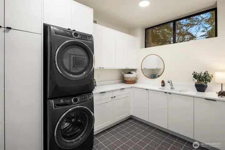 The utility room is fantastic, with tile floors, quartz counters and plenty of custom storage. Full size, second washer and dryer.