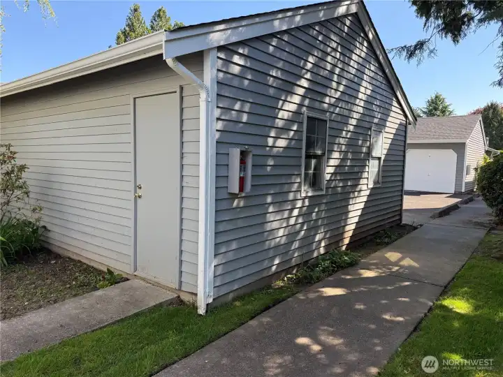 Man door access to detached garage in front of unit