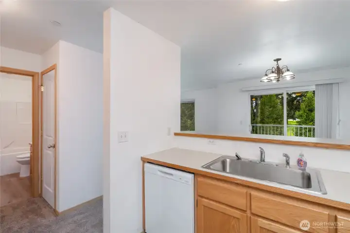 Looking from kitchen to dining and balcony.