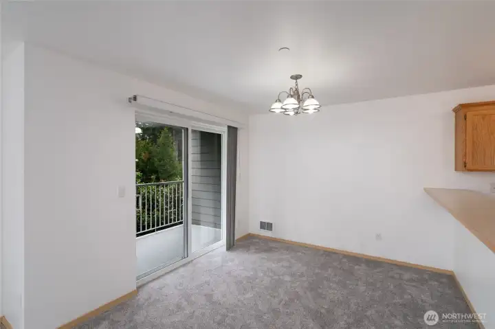 Dining room with slider to balcony patio.