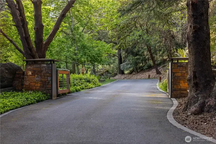 The main entrance gate, one of two gated driveways to the property, the second of which leads to the maintenance shop and garage. The main entrance gate, one of two gated driveways to the property, the second of which leads to the maintenance shop and garage.