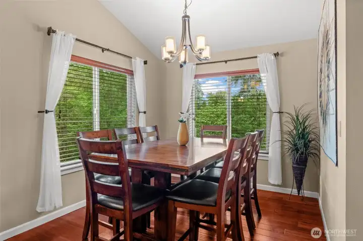 Formal dining space off front living room and kitchen. Large picture windows look over gorgeous private backyard.