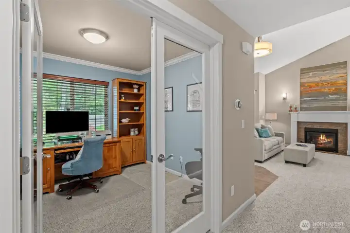 Main floor office with glass French doors, overlooks front yard & driveway.