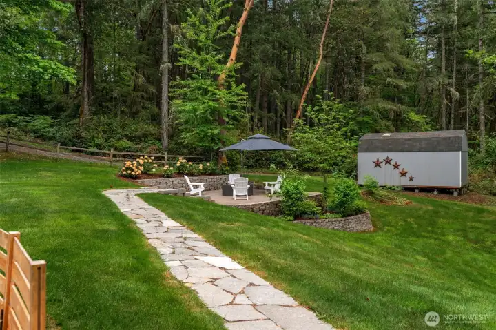 Charming path from deck to gorgeous patio.