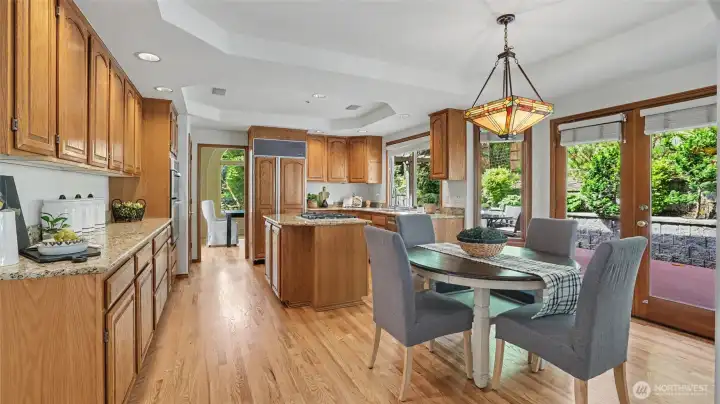 Light-filled kitchen with granite countertops and custom oak cabinetry. Light-filled kitchen with granite countertops and custom oak cabinetry.