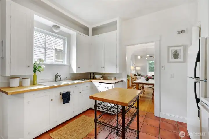 The kitchen blends vintage charm with modern touches, like new butcher block countertops.