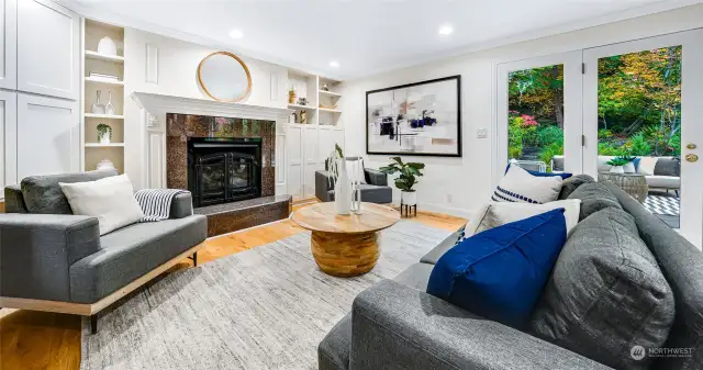 The open family room with gas fireplace that leads out to the tranquil backyard and everyday dining.