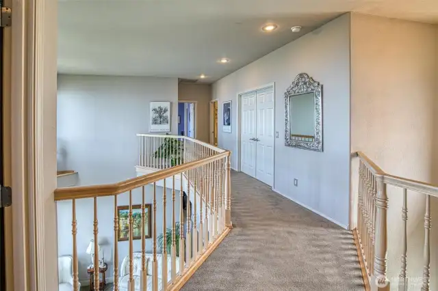 The upper level walkway with a view, leads to the bedrooms and home theater.