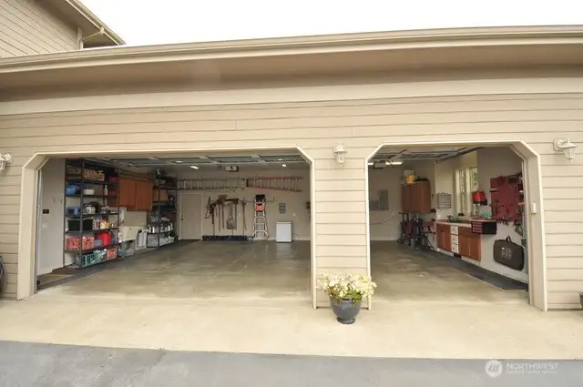 The perfect 3 car garage with lot of room room for your cars, toys, storage, and a work bench with a window.