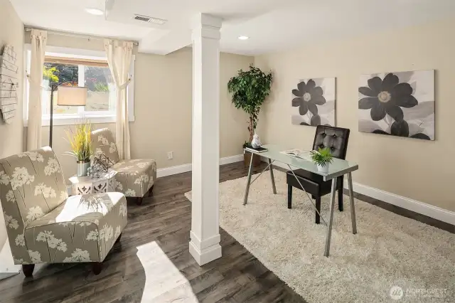 Extra finished room with laminate flooring.