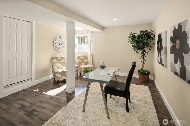 Another view of the extra finished room with laminate flooring.