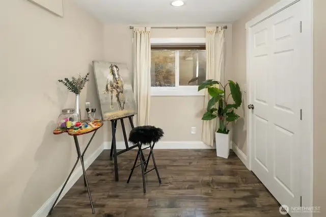 Extra finished room with laminate flooring could be used for crafts, den, or play room.