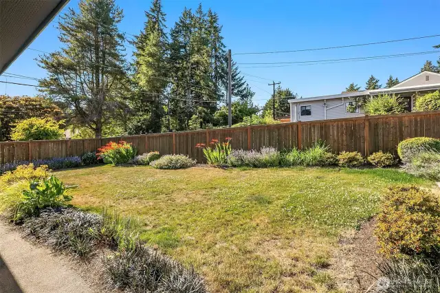 A fully fenced backyard built for both relaxation and productivity.