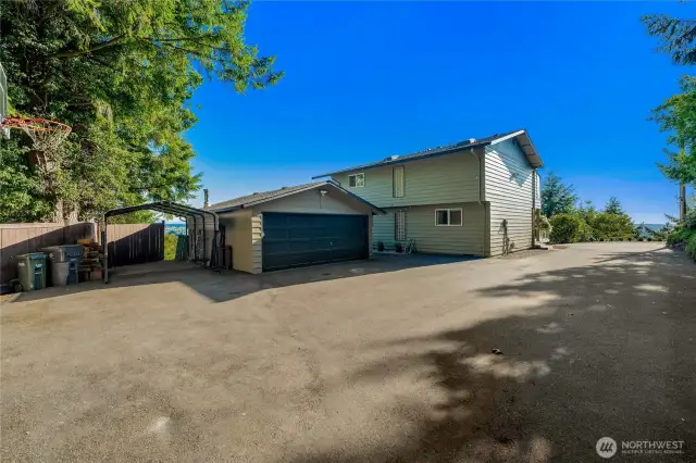 Courtyard driveway with 2 car garage and carport. Plenty of space for RV parking.