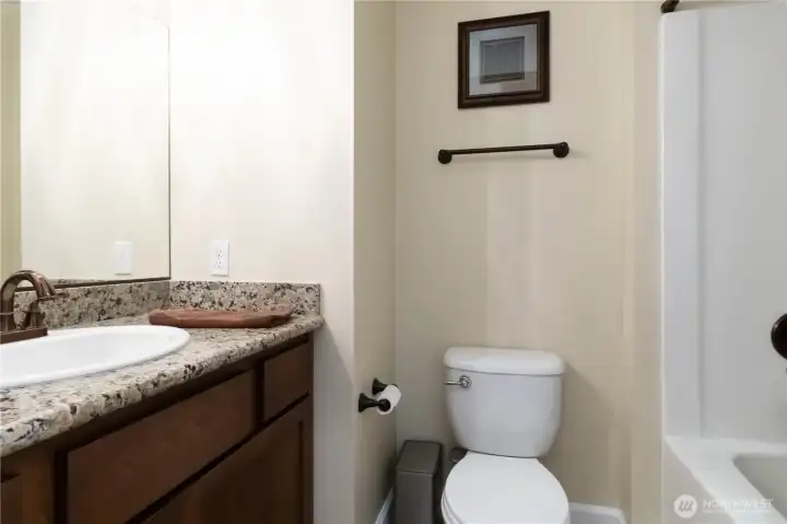 Conveniently located downstairs full bath with stylish finishes for guests.
