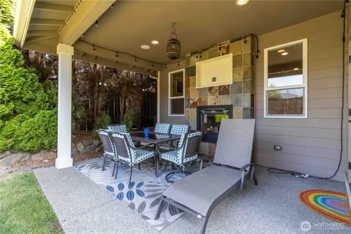 Gather around the outdoor fireplace in this covered patio retreat, perfect for year-round comfort